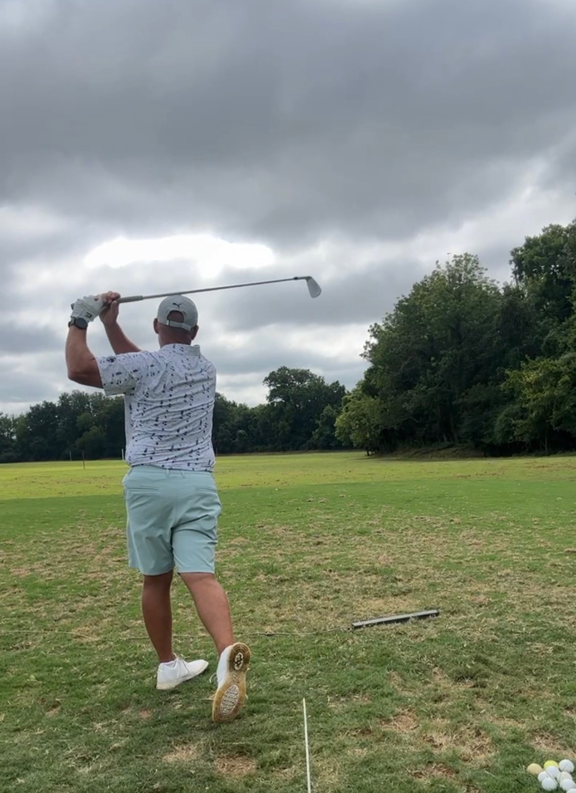 Golfer swinging on the course